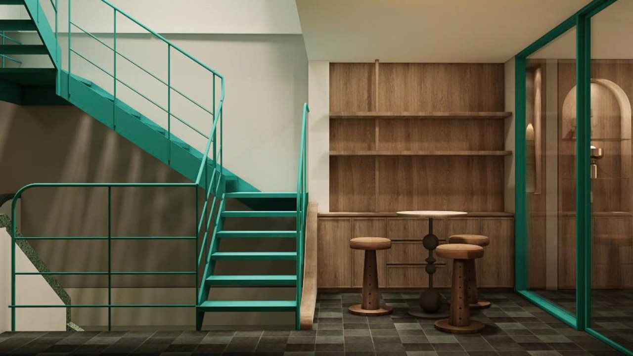 Design of FIT TOUR’s café corner – green staircase paired with rustic wooden furniture